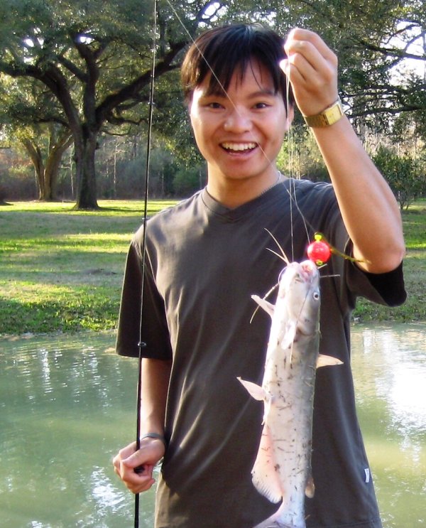 Liu holding a fish he had just caught.